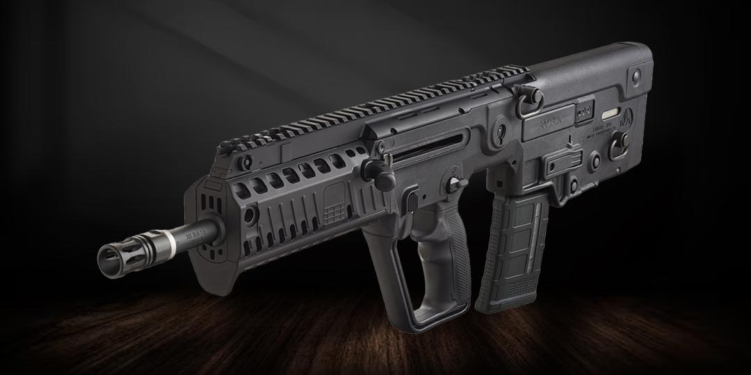 A black IWI Tavor X95 rifle on a dark background