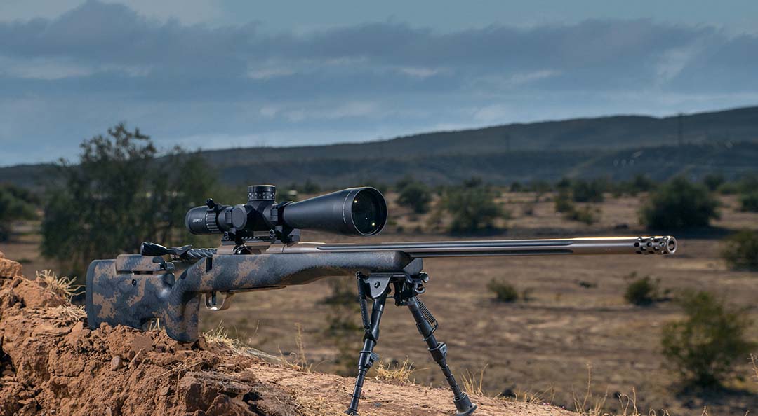 A black Weatherby Mark V rifle placed on a stand